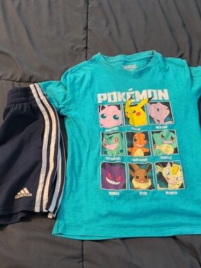 Pokémon Graphic Tee in Teal with Character Grid And Navy Blue Adidas Shorts.